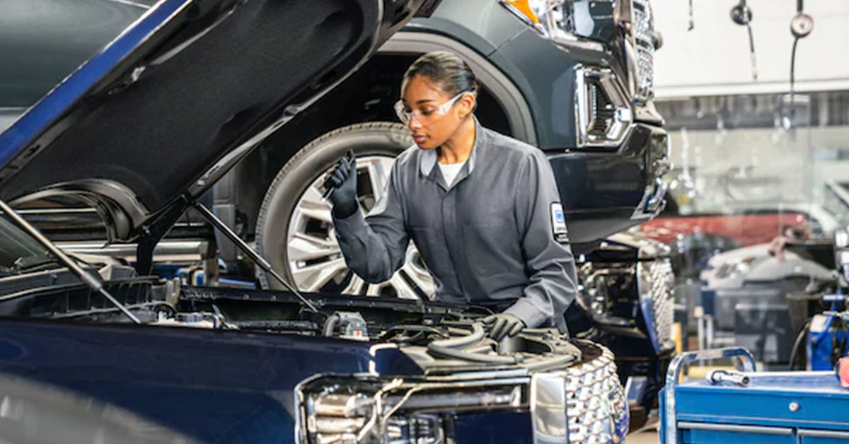 GMC service technician checking under the hood