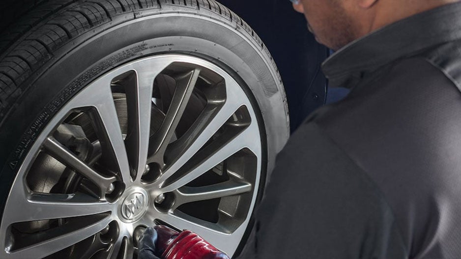 Car Technician working on Wheel