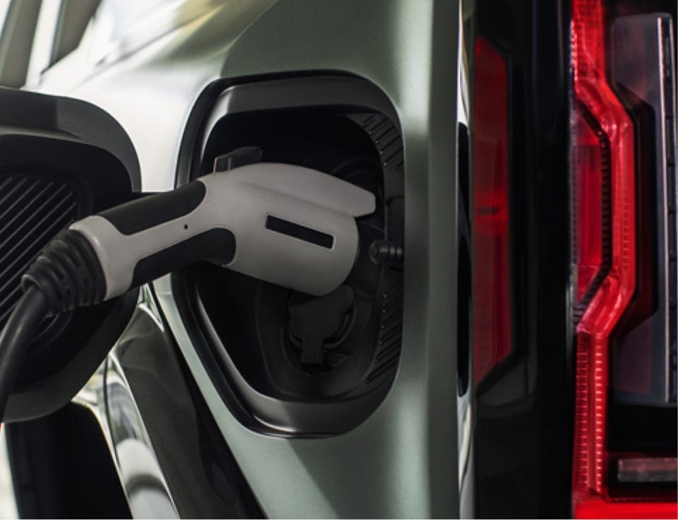 Close up of charging port with charger plugged in on a GMC Hummer EV SUV - Findlay GMC Prescott in Prescott AZ