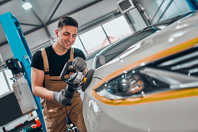 Technician Detailing a Car